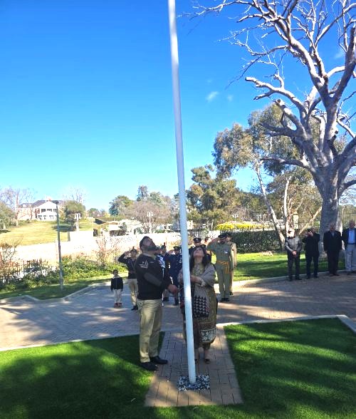People standing around a flag pole

AI-generated content may be incorrect.