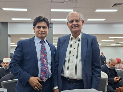 Two men in suits standing in a room

AI-generated content may be incorrect.