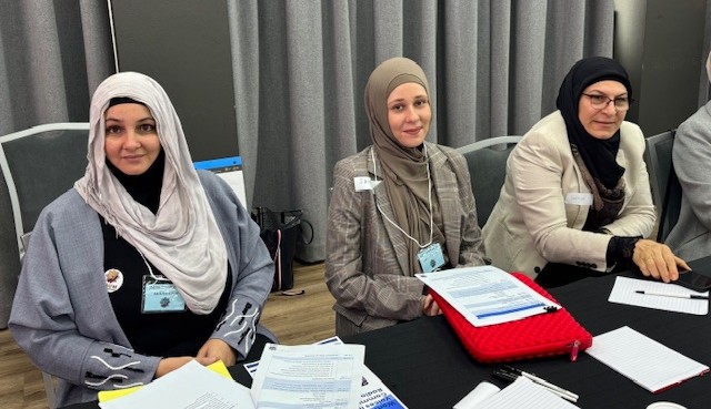 A group of women sitting at a table

AI-generated content may be incorrect.