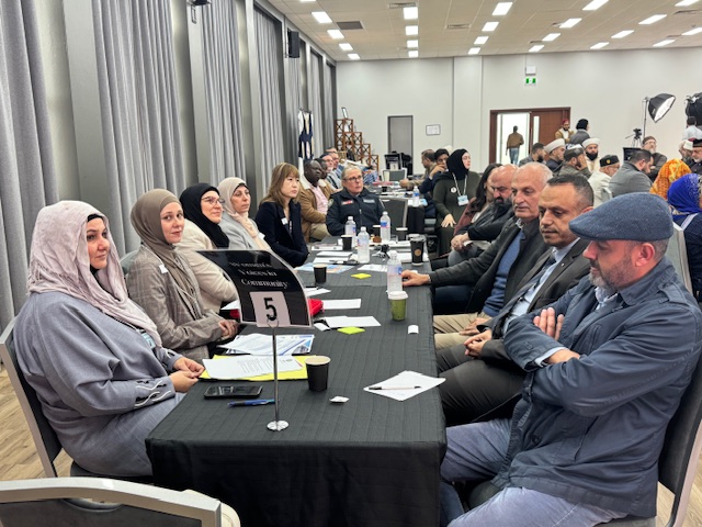 A group of people sitting at a table

AI-generated content may be incorrect.