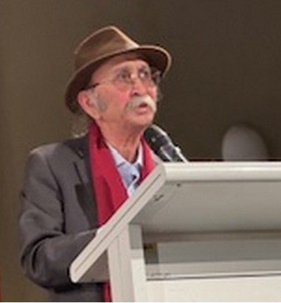 A person wearing a hat and a suit and glasses

AI-generated content may be incorrect.