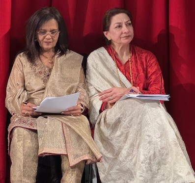 Two women sitting on a stage

AI-generated content may be incorrect.