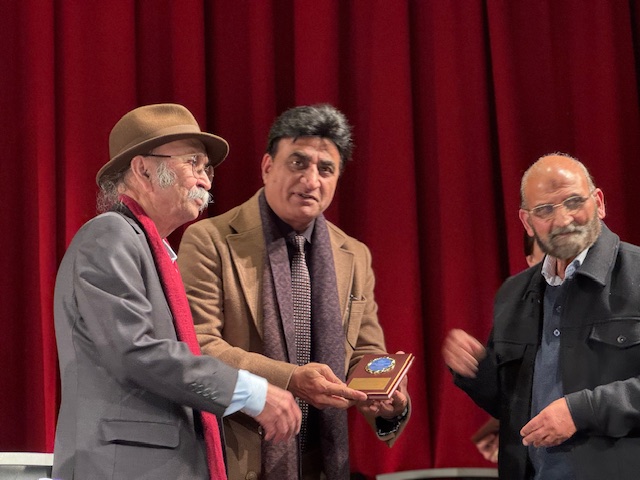 A group of men standing on stage

AI-generated content may be incorrect.