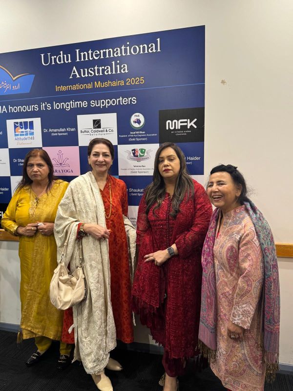 A group of women standing in front of a sign

AI-generated content may be incorrect.