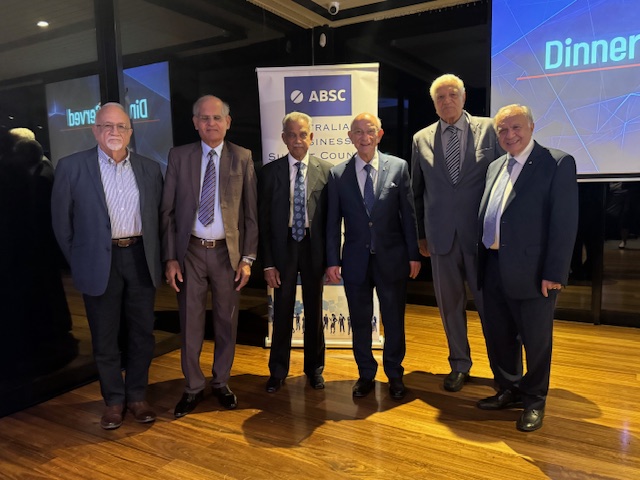 A group of men standing in front of a screen

AI-generated content may be incorrect.