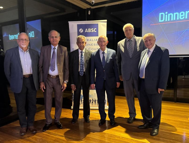 A group of men standing in front of a sign

AI-generated content may be incorrect.