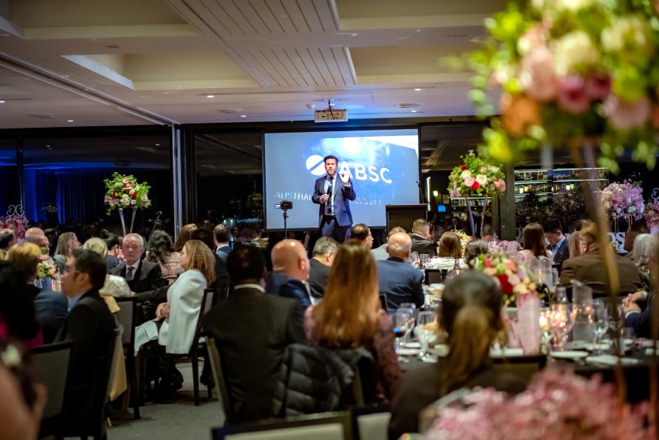 A person speaking into a microphone in front of a crowd of people

AI-generated content may be incorrect.