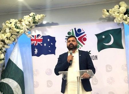 A person standing at a podium with a microphone

AI-generated content may be incorrect.