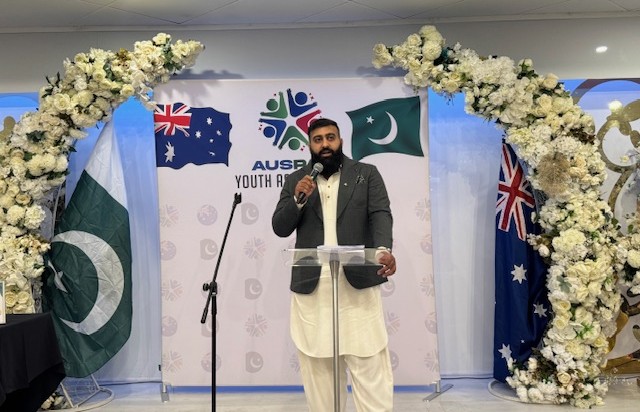 A person standing in front of a podium with a microphone

AI-generated content may be incorrect.