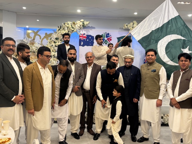 A group of men standing in a room with a flag

AI-generated content may be incorrect.