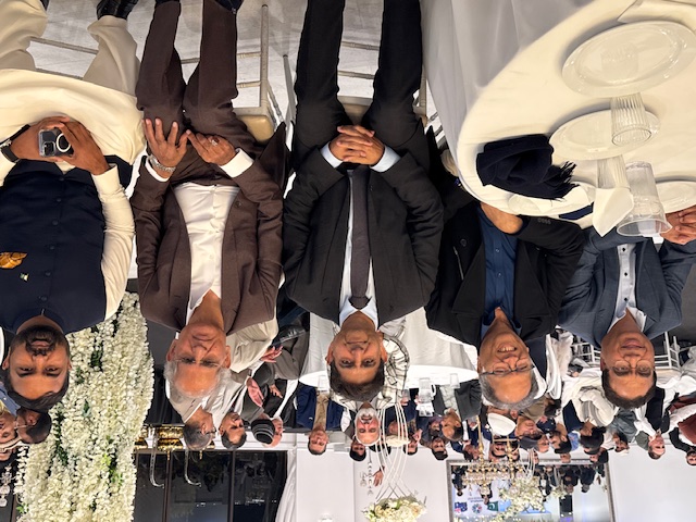 A group of people sitting at a table

AI-generated content may be incorrect.