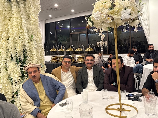 A group of men sitting at a table

AI-generated content may be incorrect.