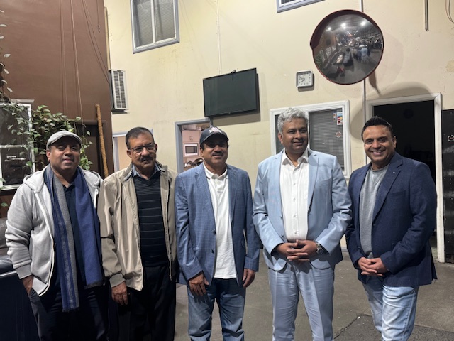 A group of men standing together

AI-generated content may be incorrect.