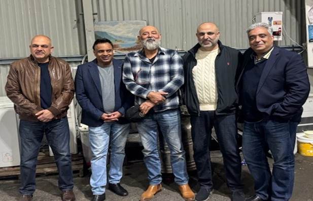 A group of men standing together

AI-generated content may be incorrect.