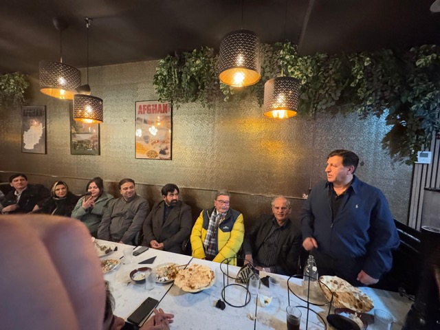 A group of people sitting at a table

AI-generated content may be incorrect.