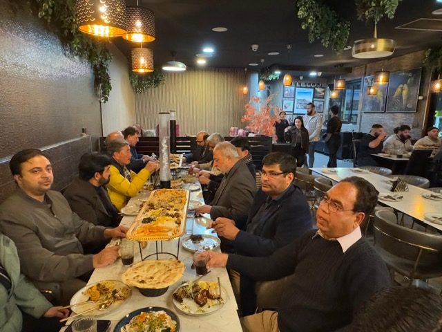 A group of people sitting at a table with food

AI-generated content may be incorrect.