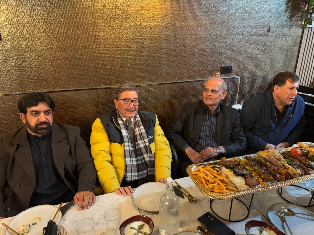 A group of men sitting at a table with food

AI-generated content may be incorrect.