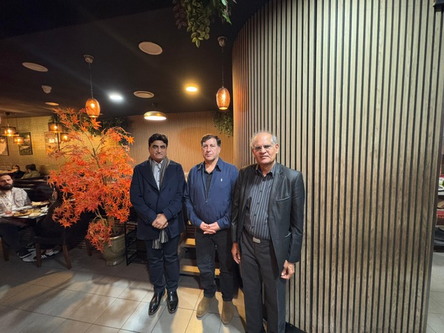 A group of men standing in front of a wall

AI-generated content may be incorrect.