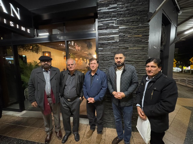 A group of men standing outside a building

AI-generated content may be incorrect.