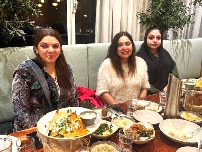 A group of women sitting at a table with food

AI-generated content may be incorrect.