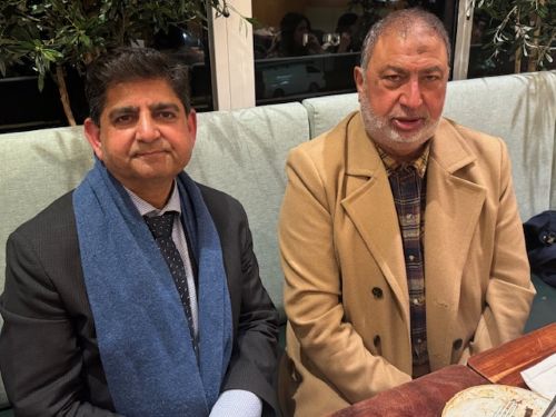 Two men sitting on a couch

AI-generated content may be incorrect.