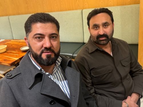 A couple of men sitting together

AI-generated content may be incorrect.