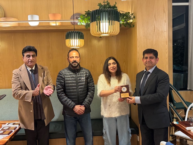 A group of people standing in front of a wood wall

AI-generated content may be incorrect.