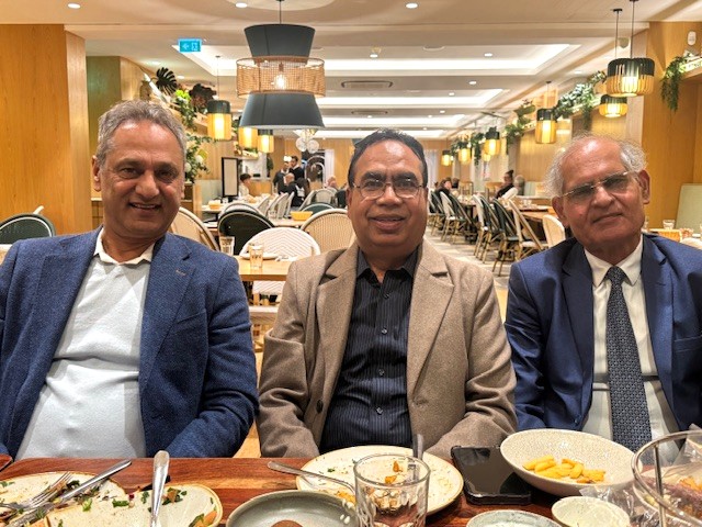 A group of men sitting at a table with food

AI-generated content may be incorrect.