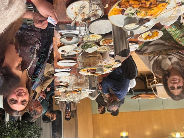 A person sitting at a table with plates of food

AI-generated content may be incorrect.