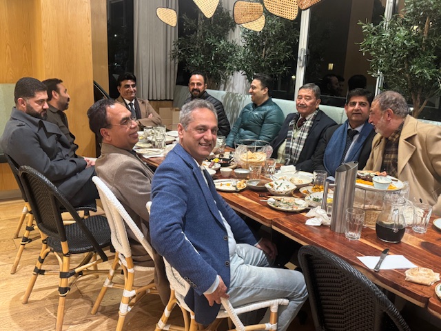 A group of men sitting at a table

AI-generated content may be incorrect.