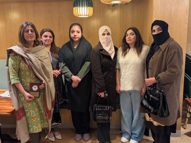 A group of women standing together

AI-generated content may be incorrect.