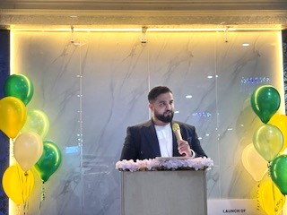 A person standing at a podium with a microphone

AI-generated content may be incorrect.