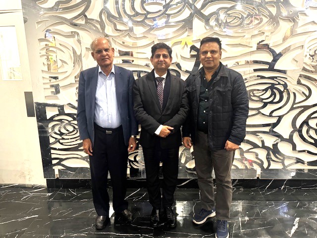 A group of men standing in front of a wall

AI-generated content may be incorrect.