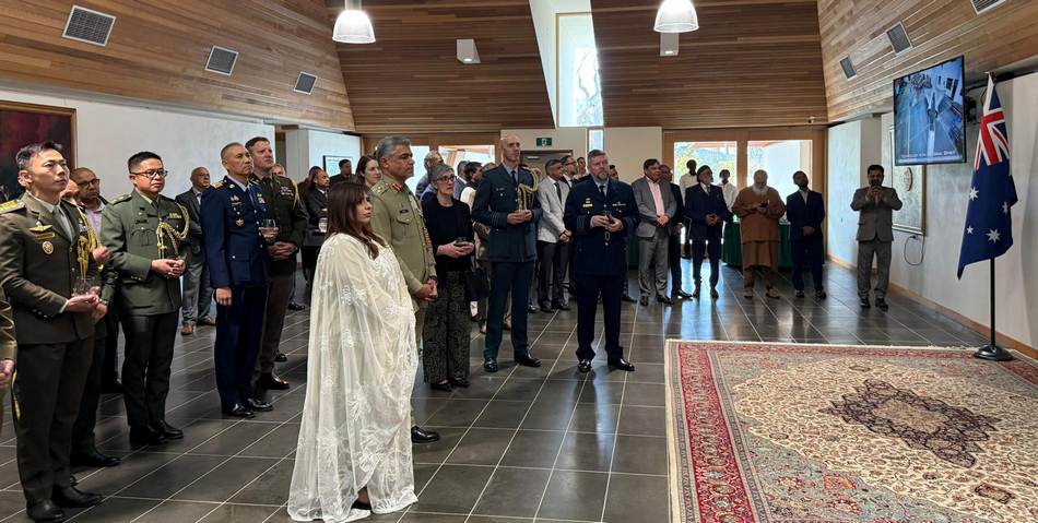 A group of people standing in a room

AI-generated content may be incorrect.