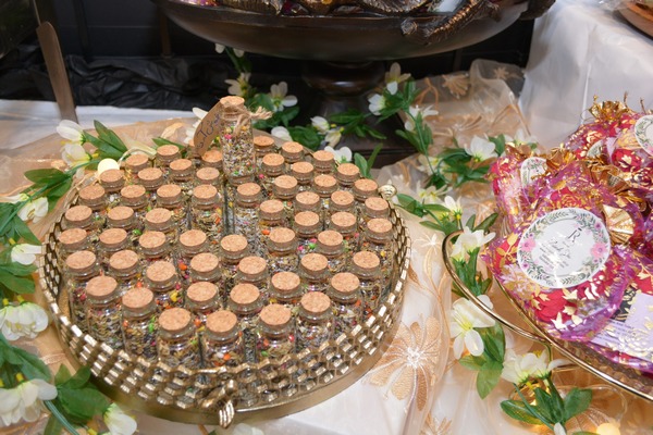 A close-up of a tray of small bottles

AI-generated content may be incorrect.