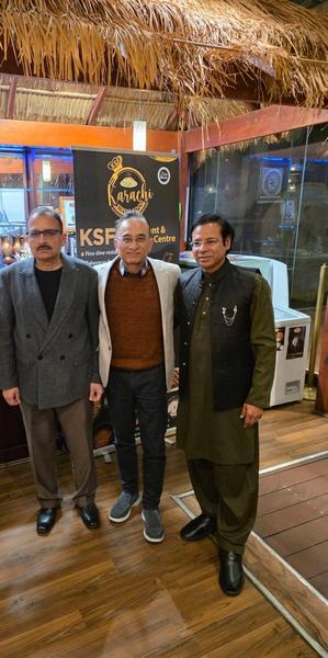 A group of men standing in front of a sign

AI-generated content may be incorrect.