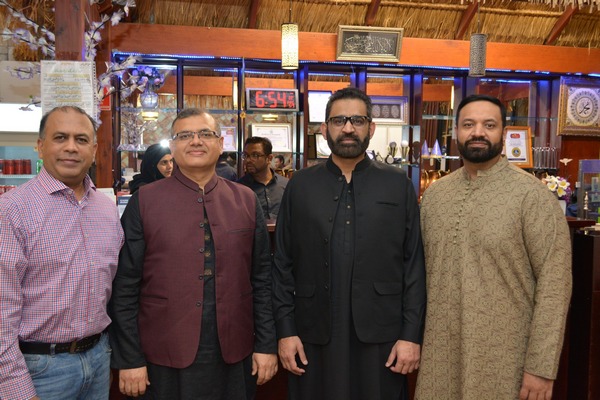 A group of men standing in a room

AI-generated content may be incorrect.