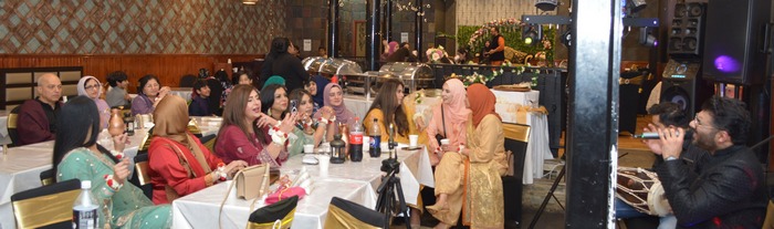 A group of people sitting at a table

AI-generated content may be incorrect.