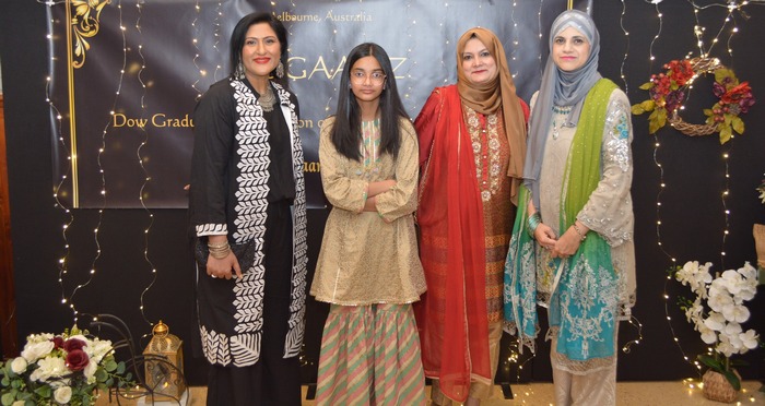 A group of women standing in front of a banner

AI-generated content may be incorrect.