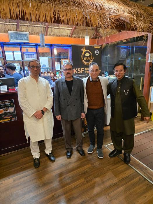 A group of men standing in a room

AI-generated content may be incorrect.