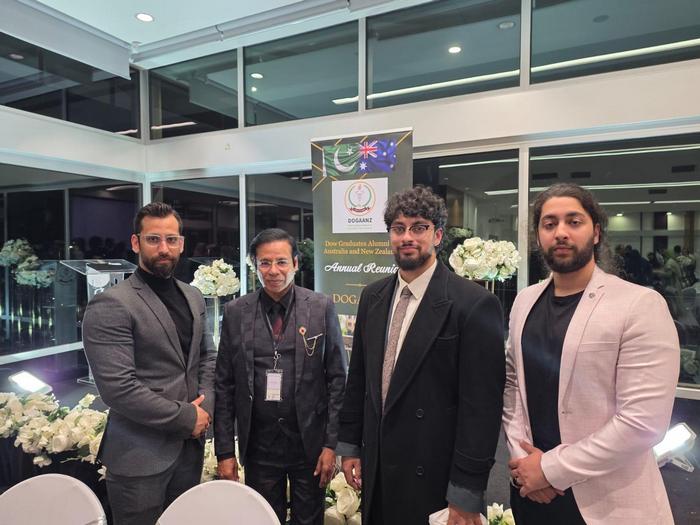 A group of men standing in front of a sign

AI-generated content may be incorrect.