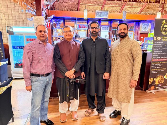 A group of men standing in a room

AI-generated content may be incorrect.