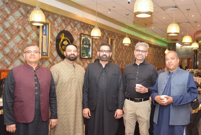 A group of men standing in a room

AI-generated content may be incorrect.