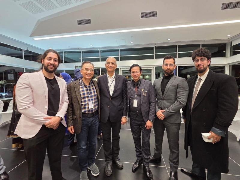 A group of men standing in a room

AI-generated content may be incorrect.