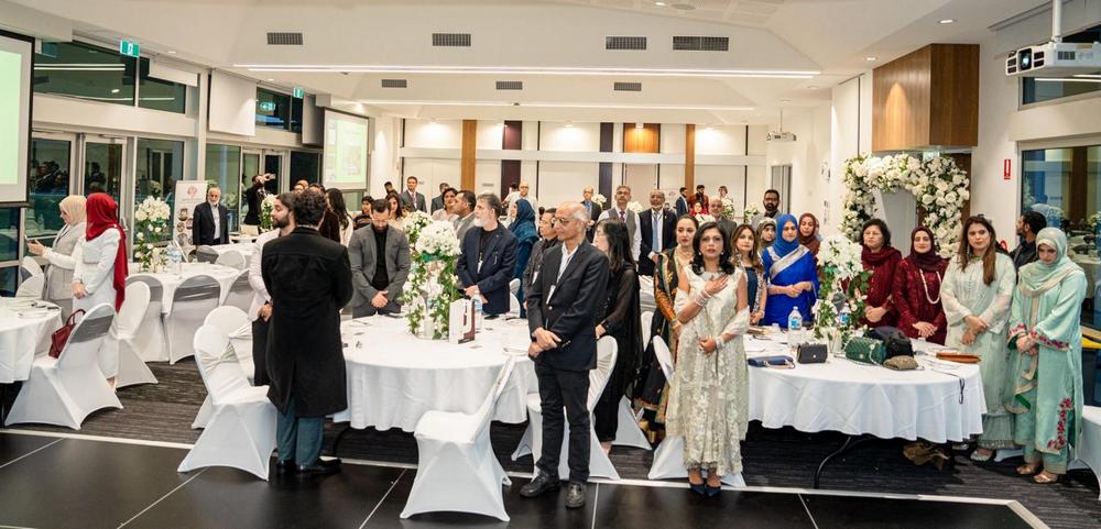 A group of people standing around a table

AI-generated content may be incorrect.