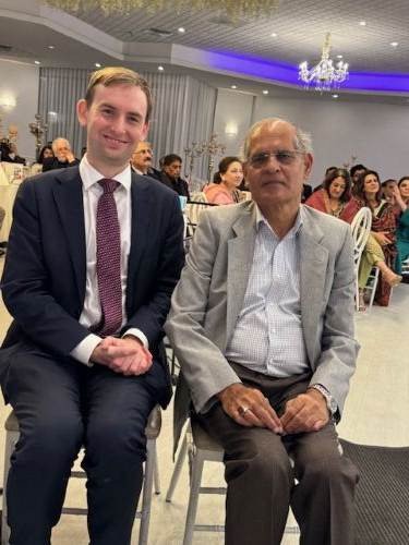 A person sitting in a chair with a person in a suit

AI-generated content may be incorrect.