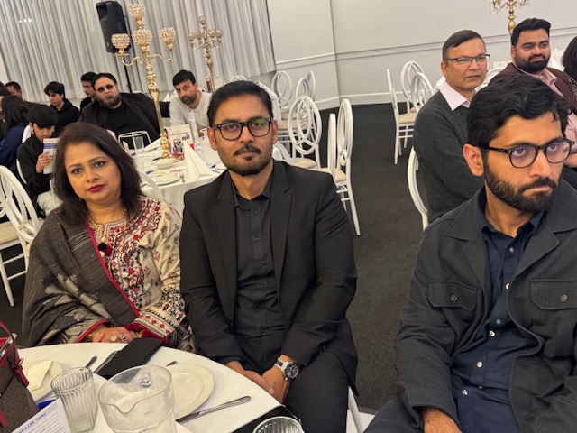 A group of people sitting at a table

AI-generated content may be incorrect.