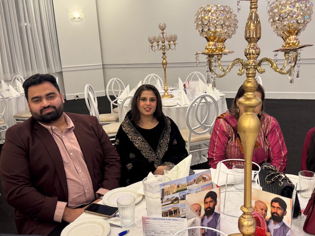 A group of people sitting at a table

AI-generated content may be incorrect.