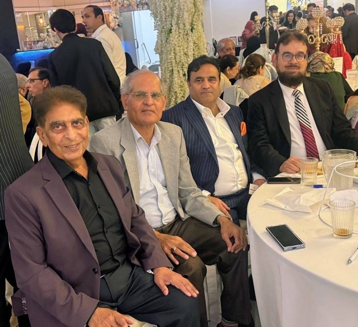 A group of men sitting at a table

AI-generated content may be incorrect.