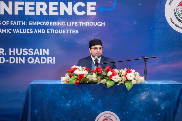 A person standing at a podium with a microphone

AI-generated content may be incorrect.